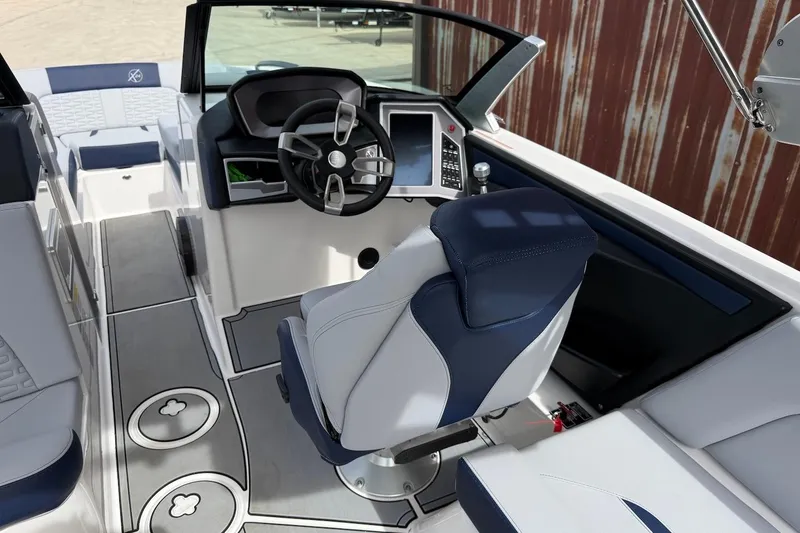 Slide: The Image of 2024 MasterCraft X24 boat interior with modern steering and seating design. - 8