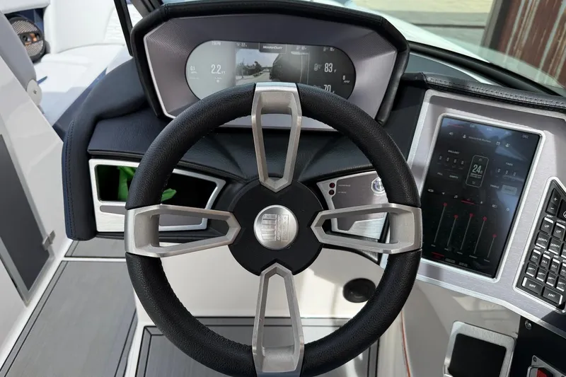 Slide: The Image of 2024 MasterCraft X24 dashboard with steering wheel and digital display. - 9