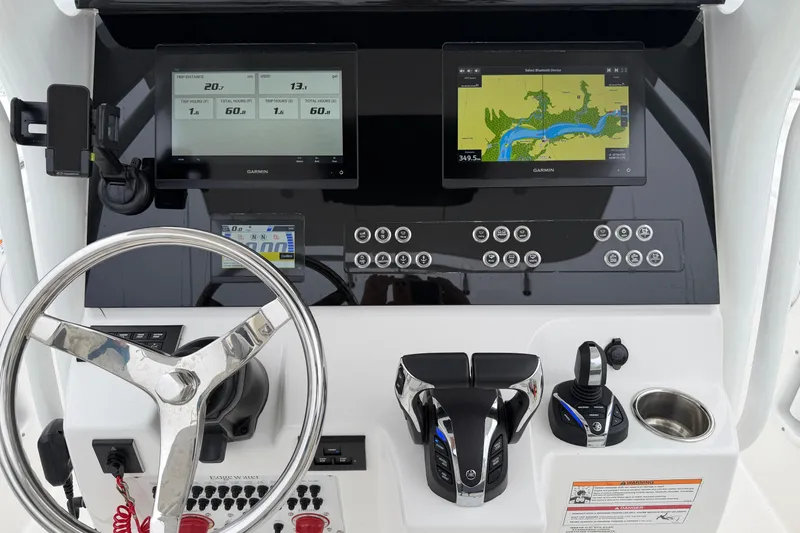 Slide: The Image of 2024 Edgewater 262CC boat dashboard with Garmin displays and modern controls. - 22