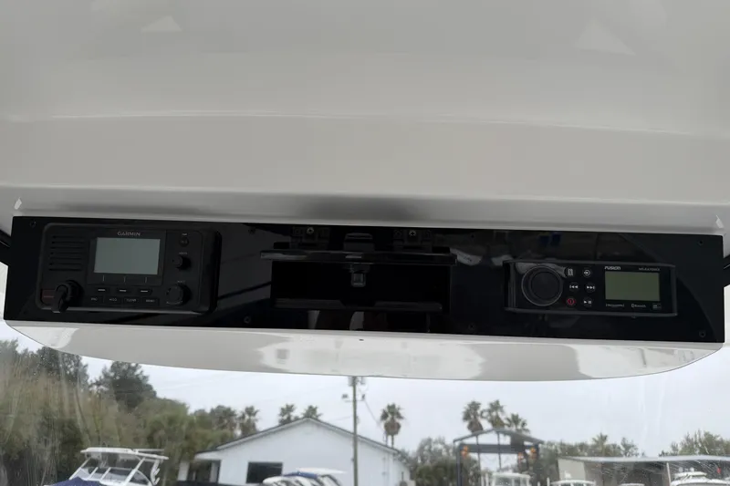 Slide: The Image of 2024 Edgewater 262CC dashboard featuring Garmin and Fusion marine electronics. - 23