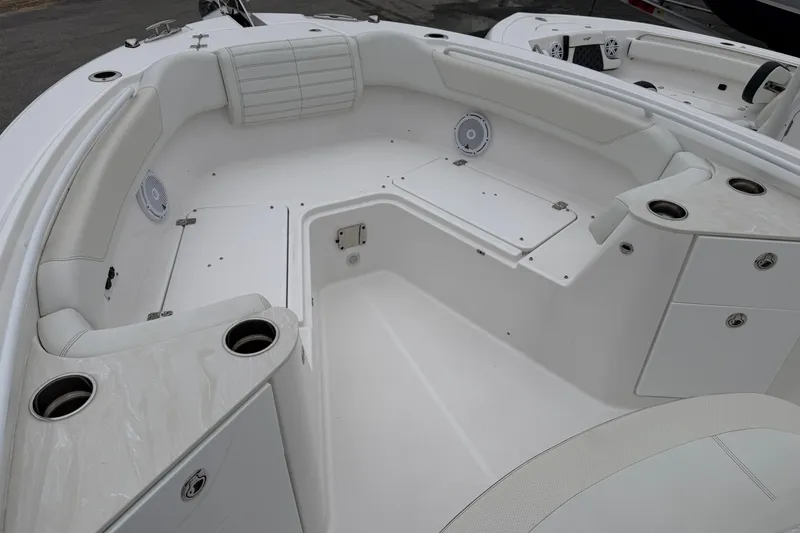 Slide: The Image of 2024 Edgewater 262CC boat interior with white seating and cup holders. - 27