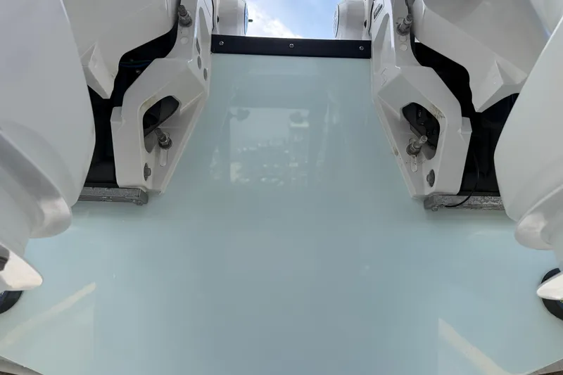 Slide: The Image of 2024 Edgewater 262CC boat transom with dual outboard motors, viewed from the rear. - 3