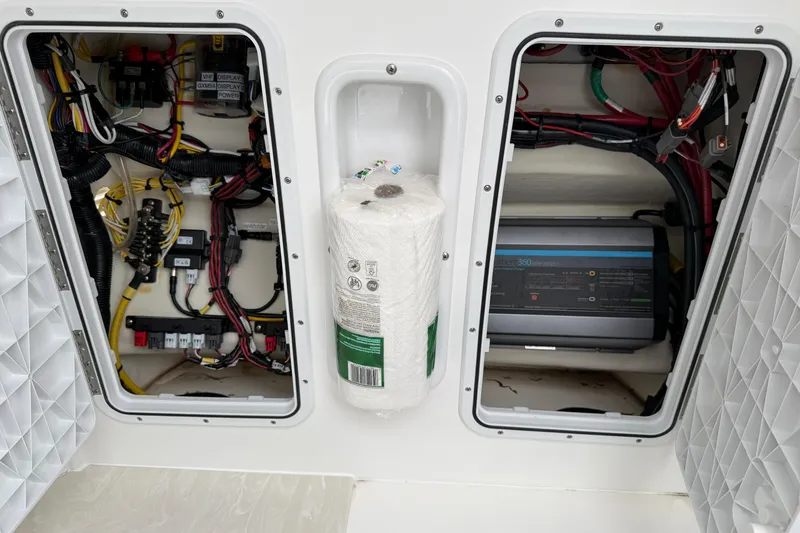 Slide: The Image of 2024 Edgewater 262CC boat electrical compartment with wiring and equipment. - 30