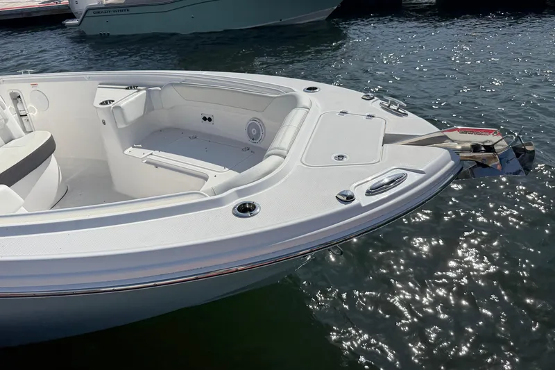 Slide: The Image of 2024 Edgewater 262CC boat bow with seating, docked on sparkling water. - 5