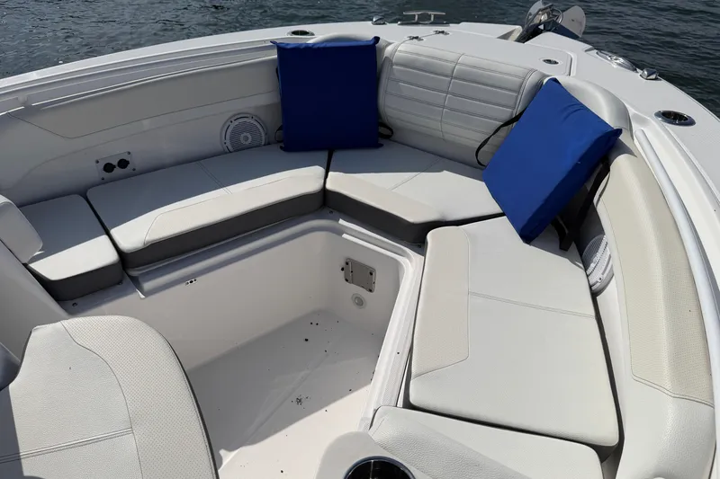 Slide: The Image of Luxurious seating area on 2024 Edgewater 262CC boat with blue cushions. - 9