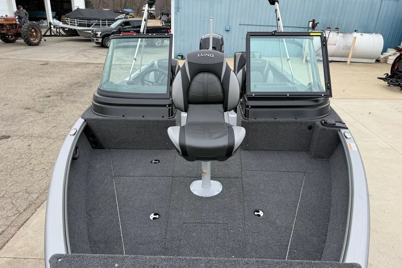 Slide: The Image of 2026 Lund 1875 Impact XS Sport boat interior with seating and windshield. - 10