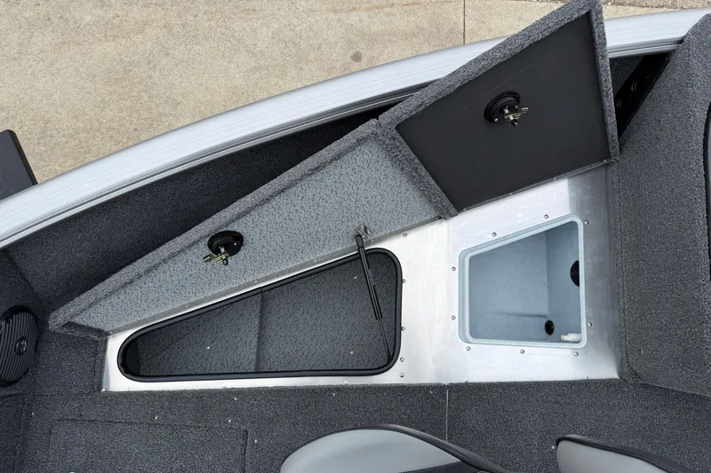 Slide: The Image of 2026 Lund 1875 Impact XS Sport boat interior storage compartments. - 13
