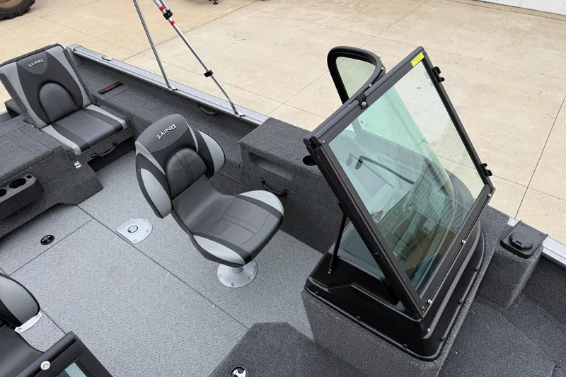 Slide: The Image of 2026 Lund 1875 Impact XS Sport boat interior with seating and windshield. - 17