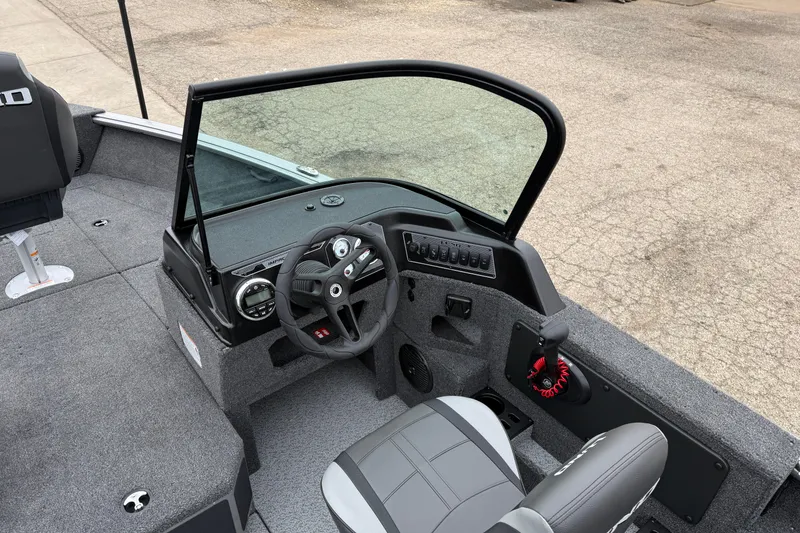 Slide: The Image of 2026 Lund 1875 Impact XS Sport boat interior with steering wheel and dashboard. - 19