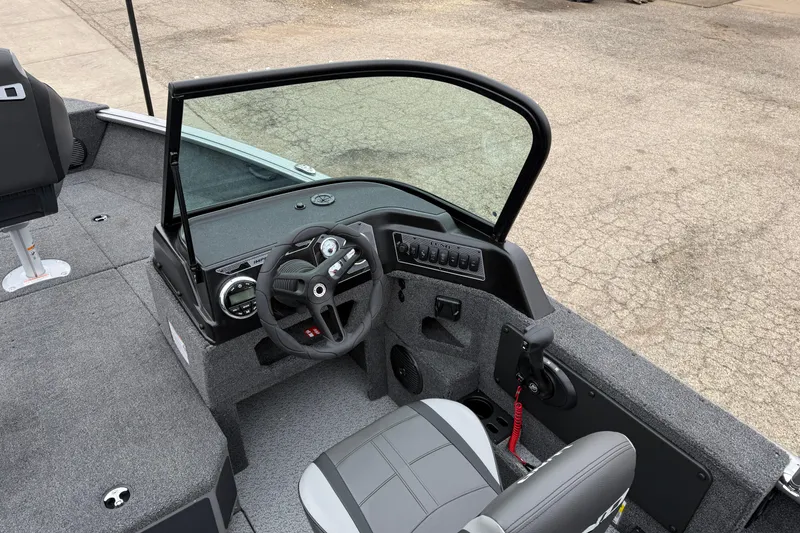 Slide: The Image of 2026 Lund 1875 Impact XS Sport boat interior with steering wheel and seating. - 20