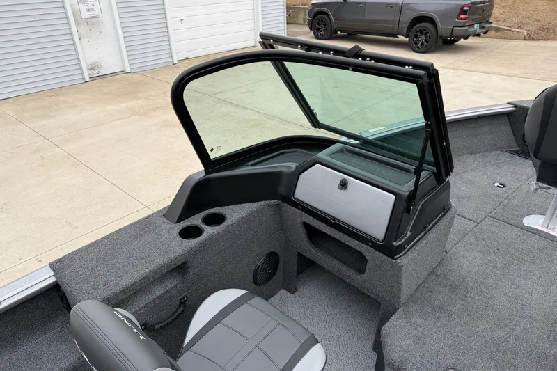 Slide: The Image of 2026 Lund 1875 Impact XS Sport boat interior with windshield and seating. - 21