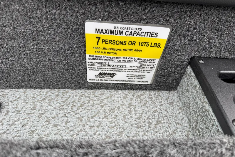 Slide: The Image of Capacity label on 2026 Lund 1875 Impact XS Sport boat, 7 persons or 1075 lbs. - 25