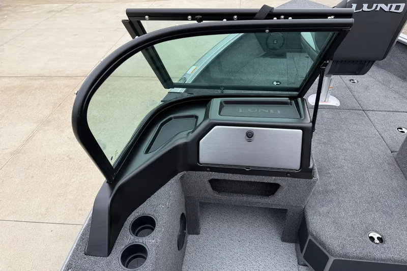 Slide: The Image of 2026 Lund 1875 Impact XS Sport boat interior with windshield and storage compartment. - 27
