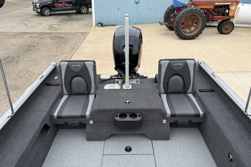 Slide: The Image of 2026 Lund 1875 Impact XS Sport boat interior with gray seating and motor. - 29