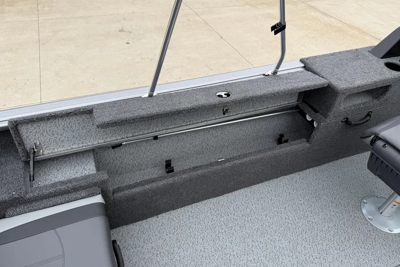 Slide: The Image of 2026 Lund 1875 Impact XS Sport boat interior with rod storage compartment. - 30