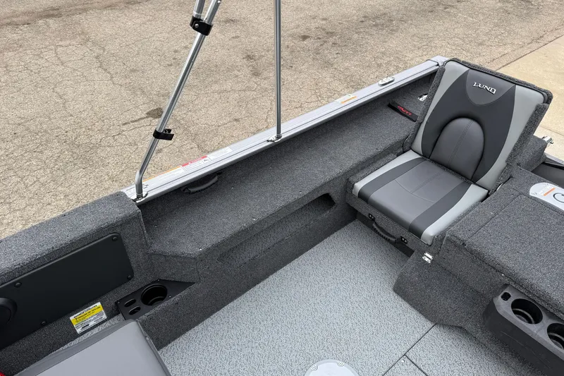 Slide: The Image of 2026 Lund 1875 Impact XS Sport boat interior with gray seating and storage compartments. - 31