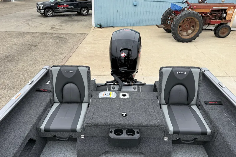 Slide: The Image of 2026 Lund 1875 Impact XS Sport boat interior with dual seats and motor. - 33