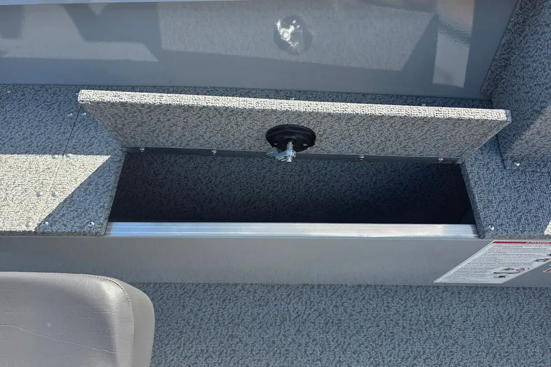 Slide: The Image of 2026 Smoker Craft Freedom 160 TL boat storage compartment with open lid. - 18
