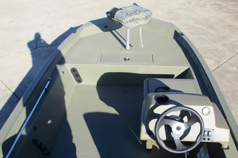 Slide: The Image of 2026 Tracker Grizzly 1754 SC boat interior with steering console and seating. - 6