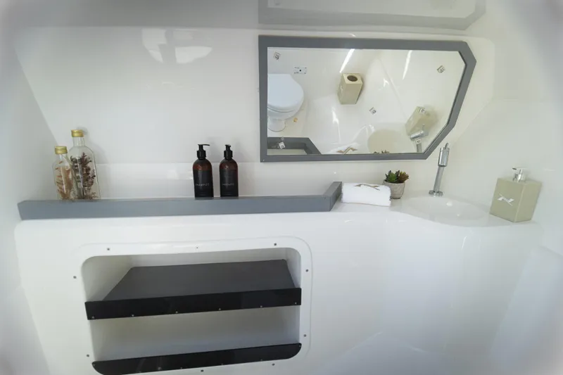 Slide: The Image of Modern bathroom interior of 2025 NX Boats NX260, featuring sleek design and amenities. - 4