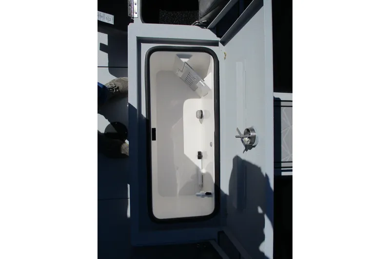 Slide: The Image of Avid 23 Fusion 2026 boat storage compartment with open lid, showcasing interior details. - 14