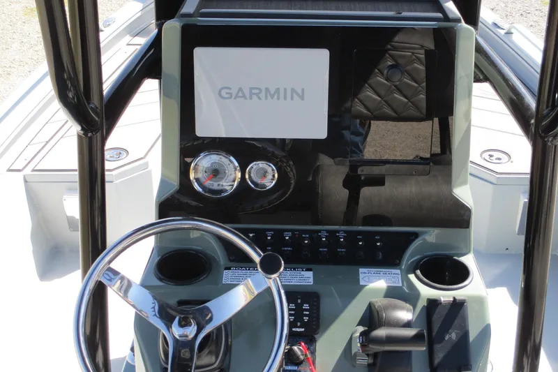 Slide: The Image of 2026 Avid 23 Fusion boat dashboard with Garmin display and steering wheel. - 16