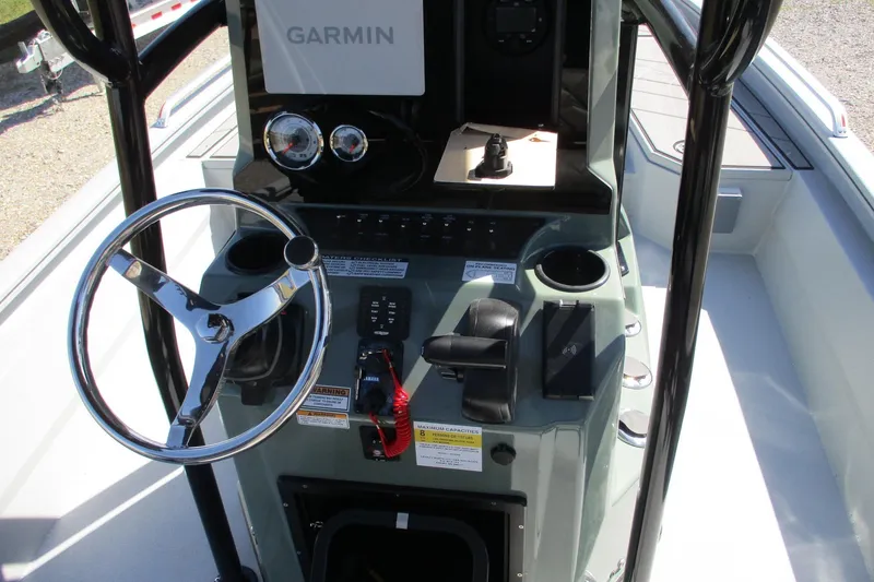 Slide: The Image of 2026 Avid 23 Fusion boat console with Garmin navigation and steering wheel. - 17