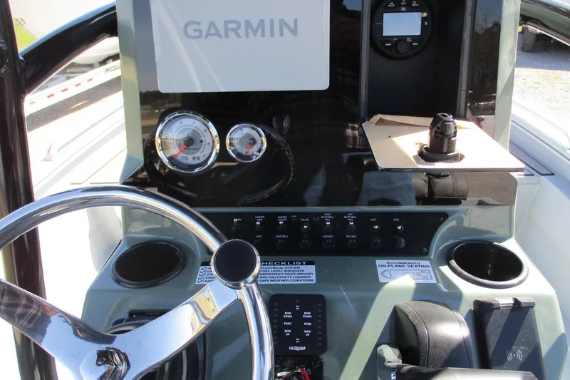 Slide: The Image of Avid 23 Fusion 2026 boat dashboard with Garmin navigation system and steering wheel. - 18