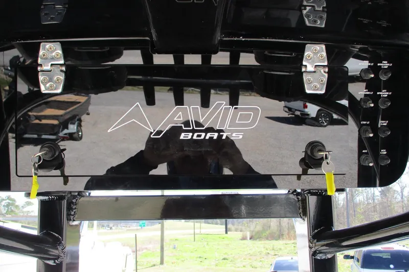 Slide: The Image of Control panel of 2026 Avid 23 Fusion boat with keys inserted. - 19