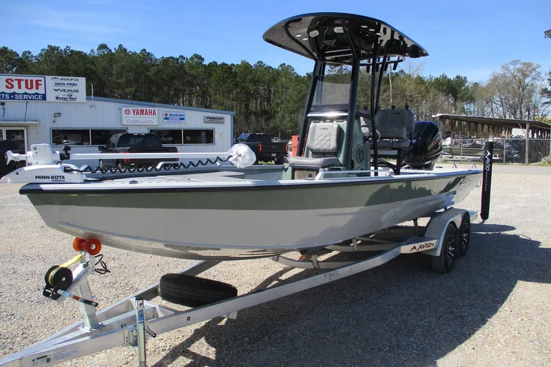 Slide: The Image of 2026 Avid 23 Fusion boat on trailer, parked outside dealership. - 2