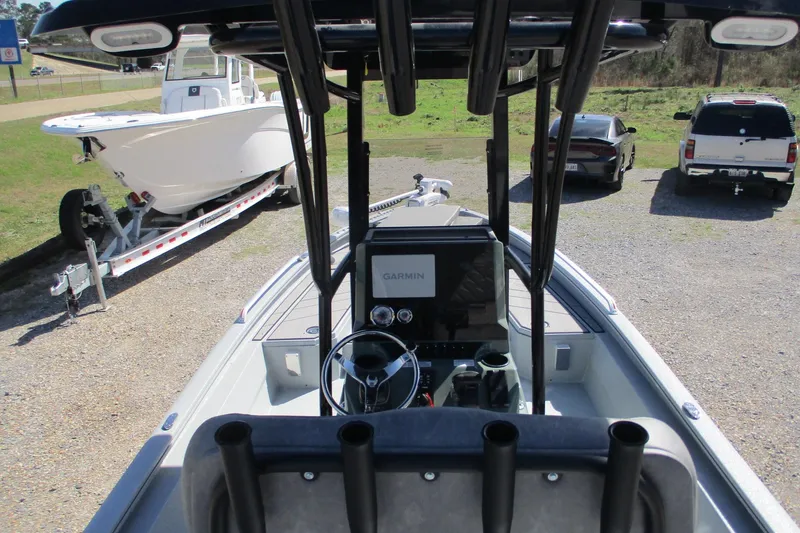 Slide: The Image of Avid 23 Fusion 2026 boat interior with Garmin navigation system, parked near vehicles. - 21