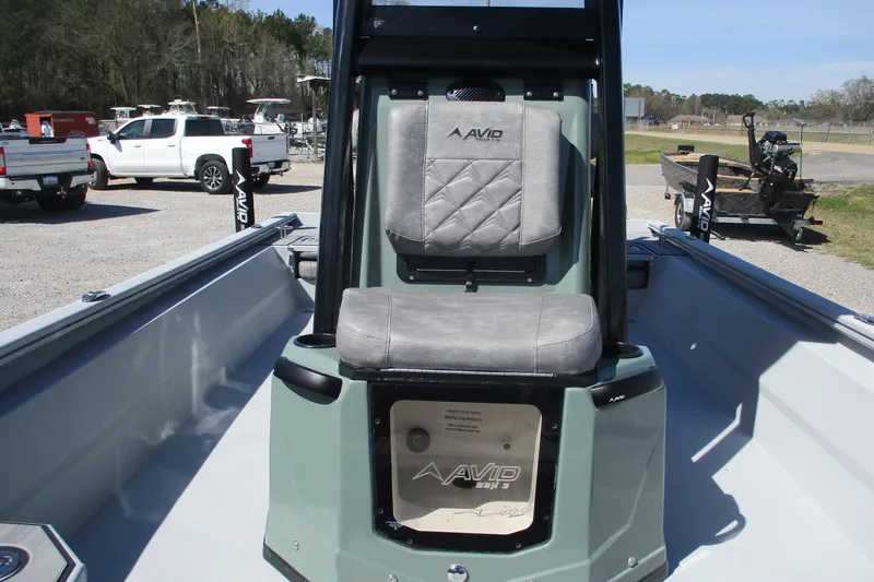 Slide: The Image of 2026 Avid 23 Fusion boat interior with cushioned seating and sleek design. - 24