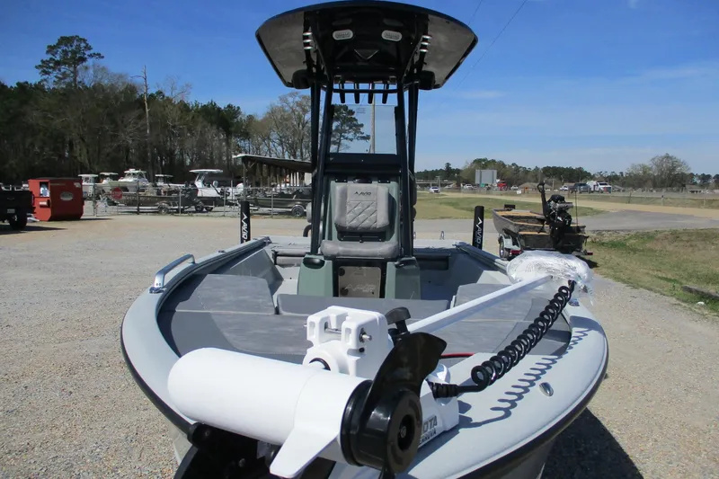 Slide: The Image of 2026 Avid 23 Fusion boat with trolling motor in a marina setting. - 3