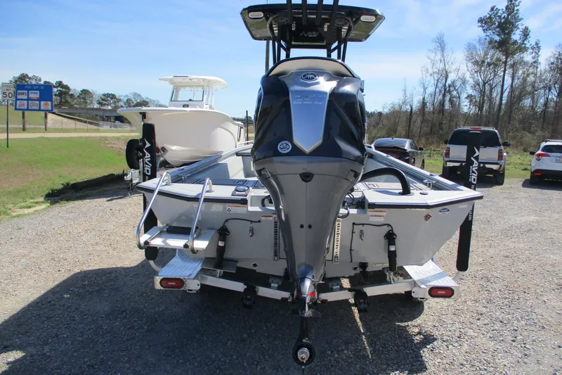 Slide: The Image of 2026 Avid 23 Fusion boat with powerful outboard motor, parked outdoors. - 6