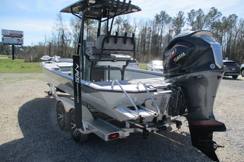 Slide: The Image of 2026 Avid 23 Fusion boat with Yamaha engine, parked outdoors on a sunny day. - 7