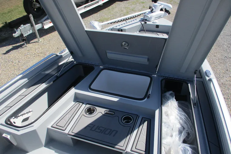 Slide: The Image of 2026 Avid 23 Fusion boat interior with storage compartments and cup holders. - 9
