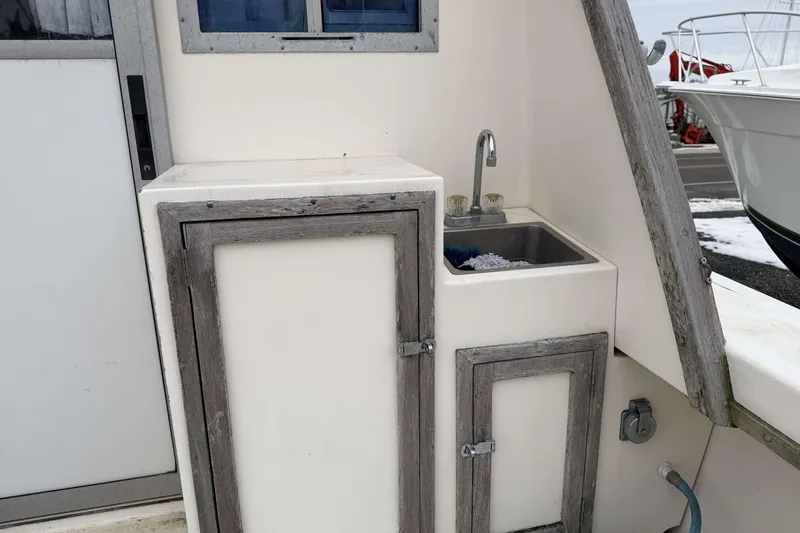 Slide: The Image of 1986 Henriques Yachts 35 Maine Coaster with outdoor sink and storage cabinet. - 11