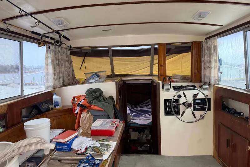 Slide: The Image of Interior of a 1986 Henriques Yachts 35 Maine Coaster with fishing gear and steering wheel. - 14