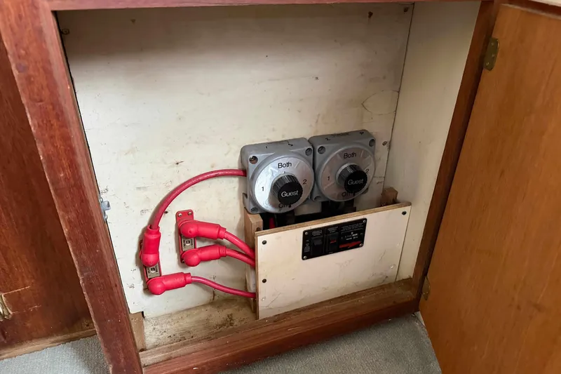 Slide: The Image of Electrical panel with switches and red cables in a 1986 Henriques Yachts 35 Maine Coaster. - 17