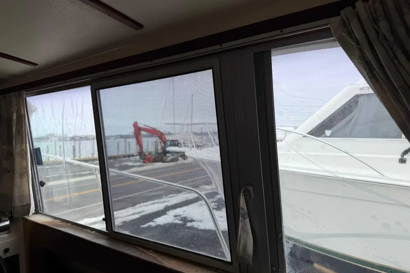 Slide: The Image of View from inside a 1986 Henriques Yachts 35 Maine Coaster, showing marina and adjacent boat. - 18