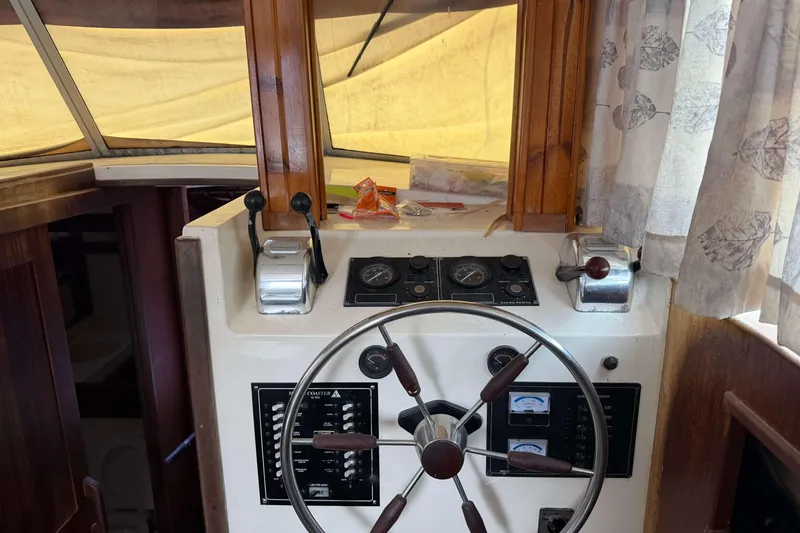 Slide: The Image of Helm of 1986 Henriques Yachts 35 Maine Coaster with steering wheel and control panel. - 19