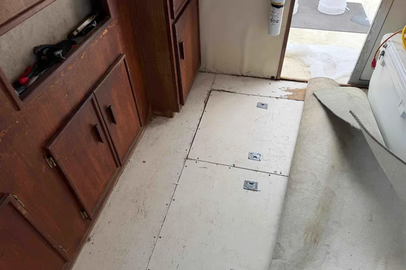 Slide: The Image of Interior of 1986 Henriques Yachts 35 Maine Coaster with wooden cabinets and partially removed carpet. - 23