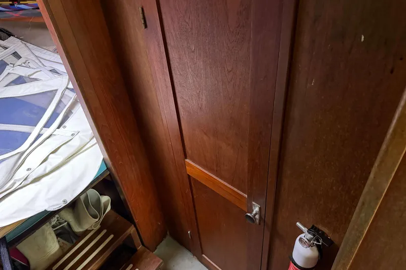 Slide: The Image of Interior of 1986 Henriques Yachts 35 Maine Coaster with wooden door and fire extinguisher. - 27
