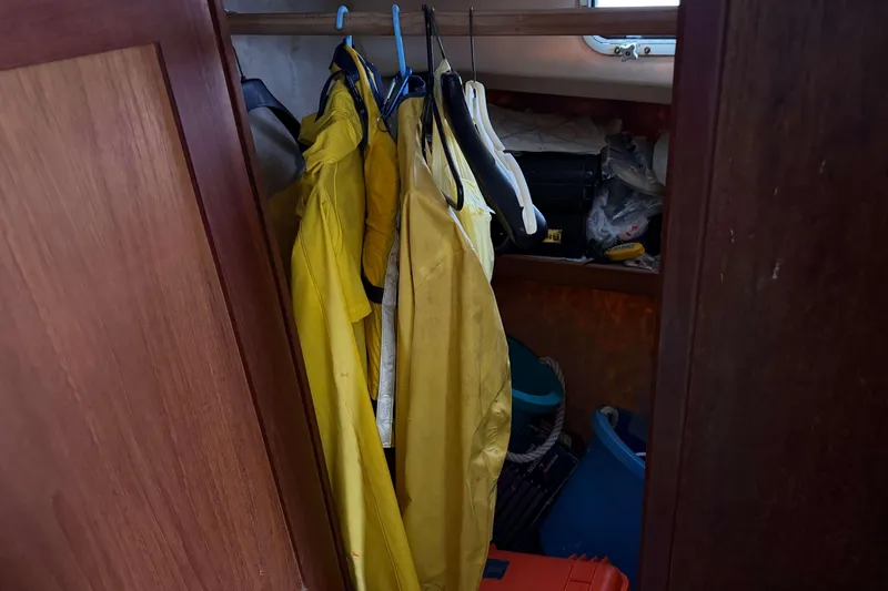 Slide: The Image of Yellow rain gear hanging in a closet on a 1986 Henriques Yachts 35 Maine Coaster. - 28