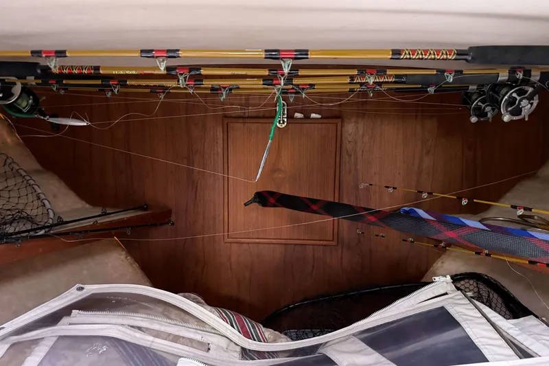 Slide: The Image of Interior of 1986 Henriques Yachts 35 Maine Coaster with fishing rods and gear storage. - 33