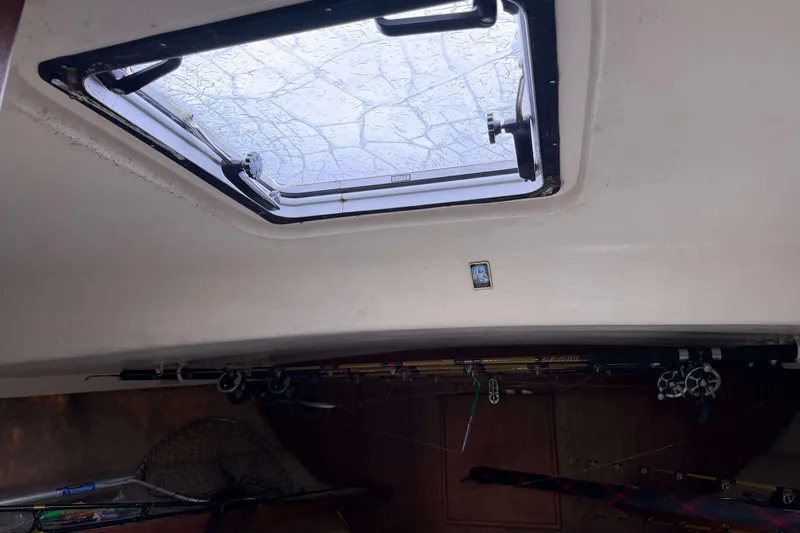 Slide: The Image of Interior view of 1986 Henriques Yachts 35 Maine Coaster with fishing rods and open hatch. - 34