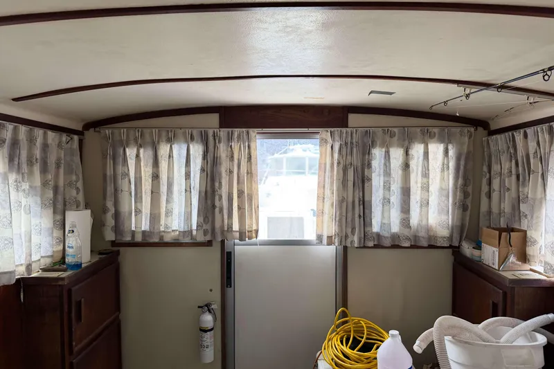 Slide: The Image of Interior of 1986 Henriques Yachts 35 Maine Coaster with curtains and nautical equipment. - 36