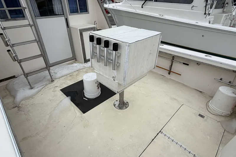 Slide: The Image of 1986 Henriques Yachts 35 Maine Coaster deck with fishing rod holders and ladder. - 4