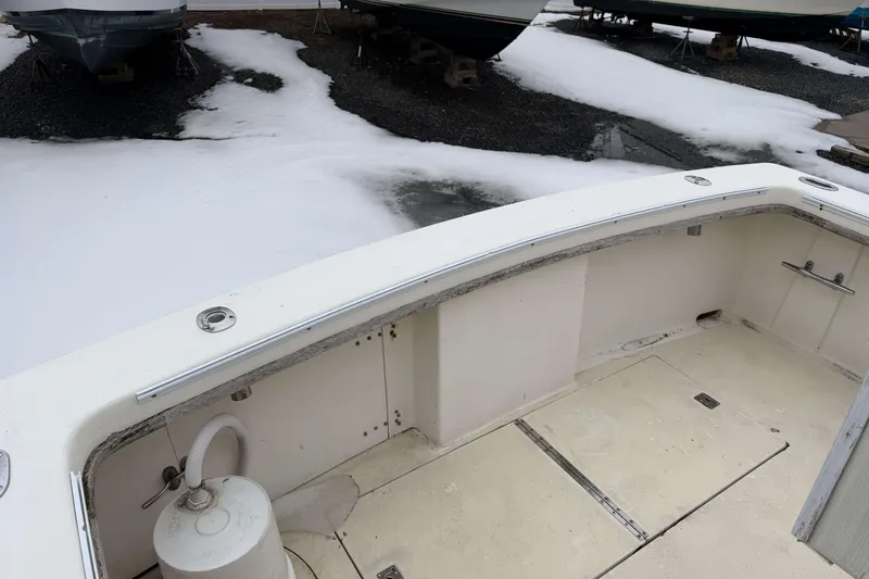 Slide: The Image of 1986 Henriques Yachts 35 Maine Coaster in snowy boatyard, showcasing deck and winter storage. - 6
