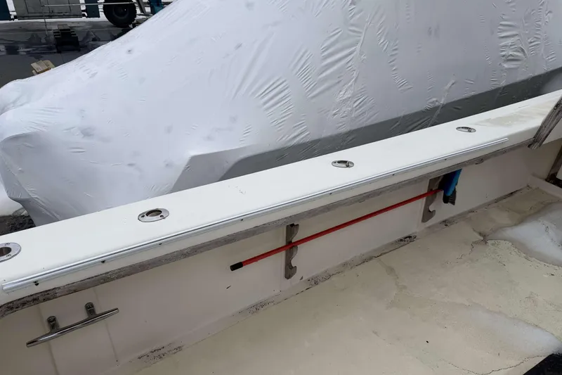 Slide: The Image of 1986 Henriques Yachts 35 Maine Coaster deck with rod holders and covered equipment. - 9